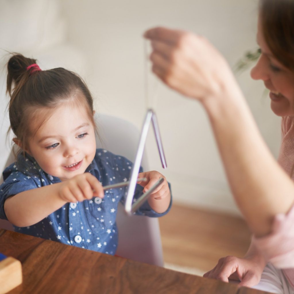 mother daughter playing triangle